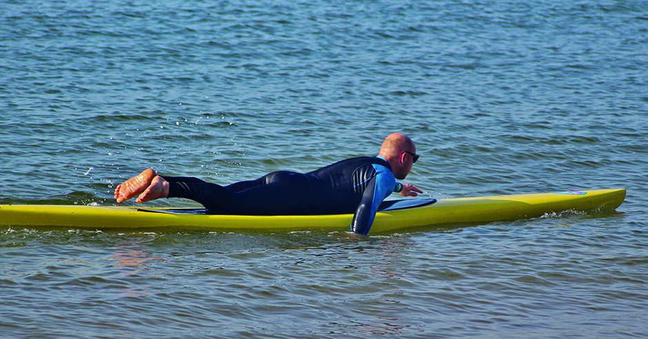 Prone paddling by Tez Plavenieks