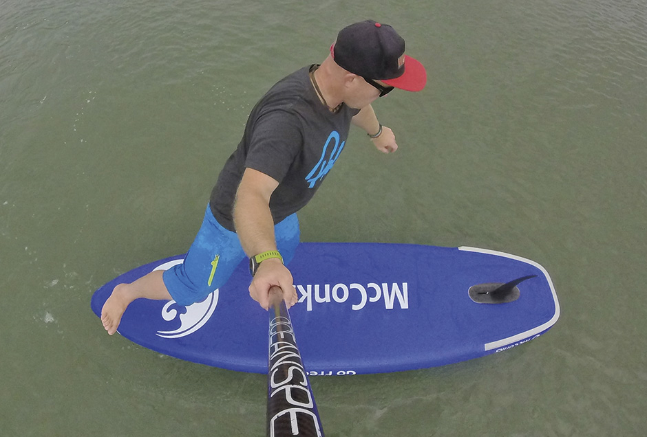 Paddling fin first, upside down with one leg in the air